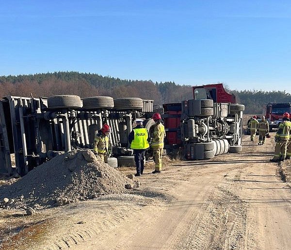 Ciężarówka przewróciła się na polu. Kierowca w kabinie